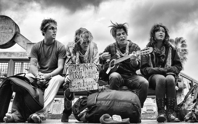A group of young hippies sing on a bench across from the Muscle Beach Gym. The boardwalk is deserted by tourists on this rainy spring day.